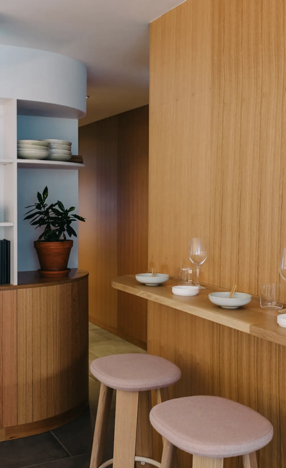 Sara restaurant custom oak millwork, curved cabinetry, and bar shelf