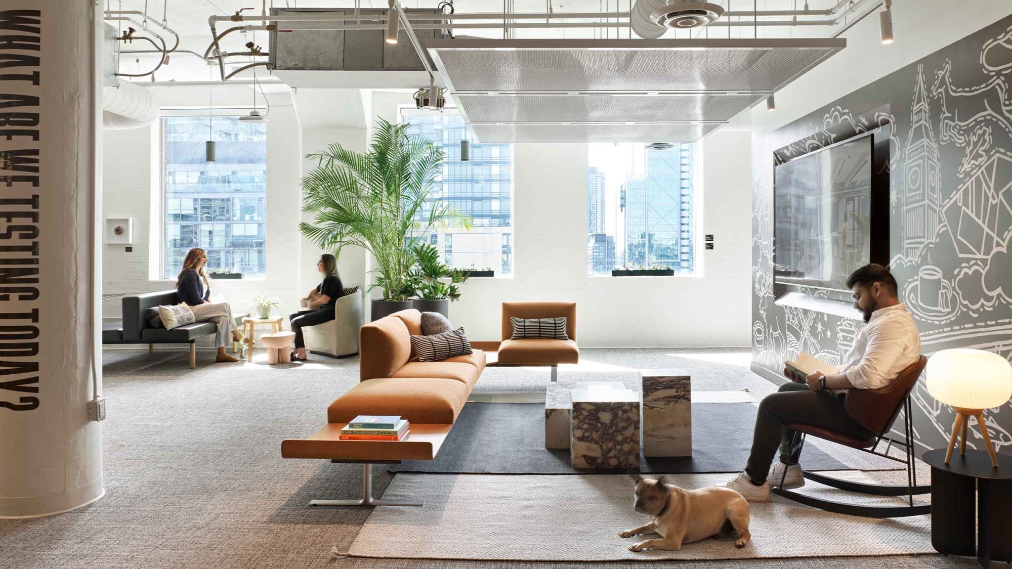 M Moser workplace lounge with city views and a custom mural